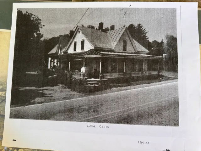 Photocopy of a Victorian farmhouse with a wraparound porch.